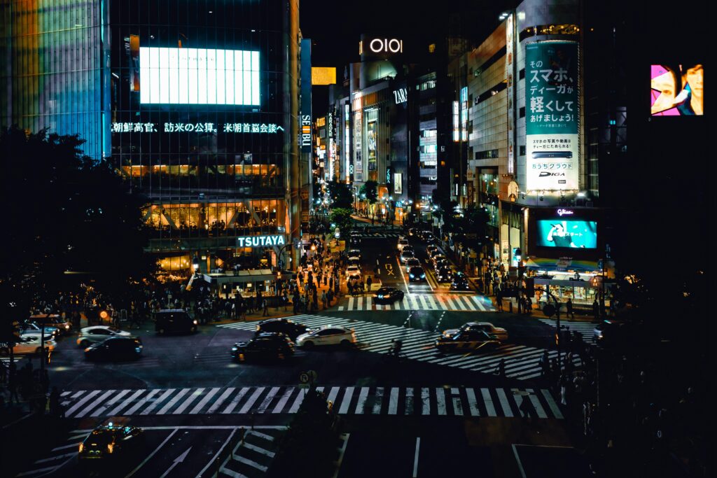 Bustling night scene at iconic Shibuya Crossing in Tokyo, filled with energy and city life.